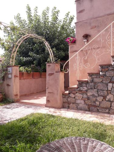 an entrance to a house with a gate and a stone wall at B&B La Torretta in Maratea