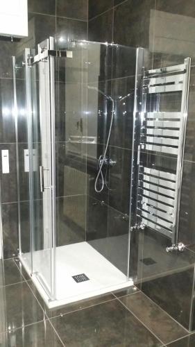 a shower with a glass door in a bathroom at Villa Cristalli clinica pc in Piacenza