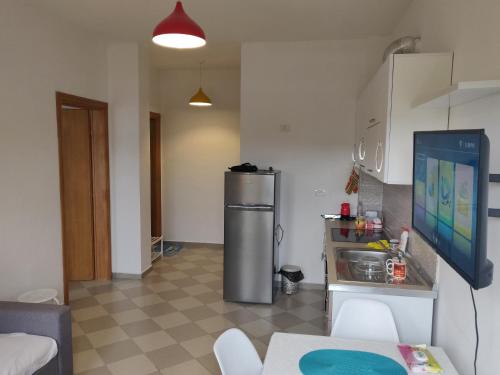 a kitchen with a stainless steel refrigerator in a room at Lovely Apartment in Golem