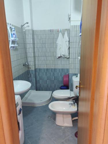a bathroom with two toilets and a sink at Lovely Apartment in Golem
