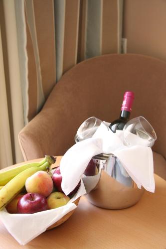 a bottle of wine and a basket of fruit at Zakantha Beach in Argasi