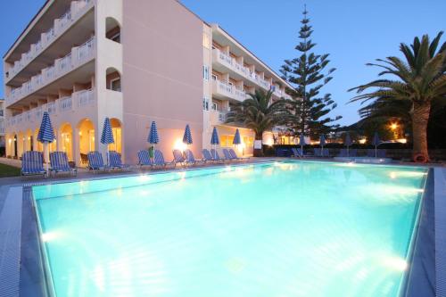a swimming pool in front of a hotel at Zakantha Beach in Argasi