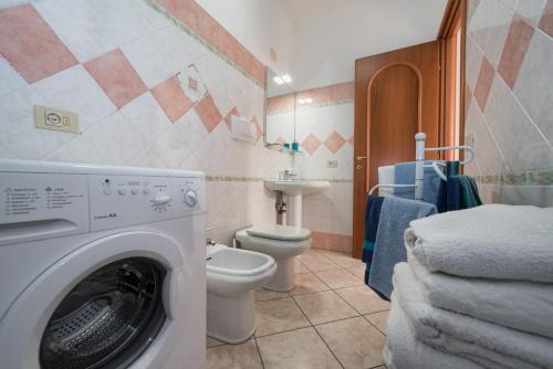 a bathroom with a washing machine and a toilet at Casa Nancy in Amalfi
