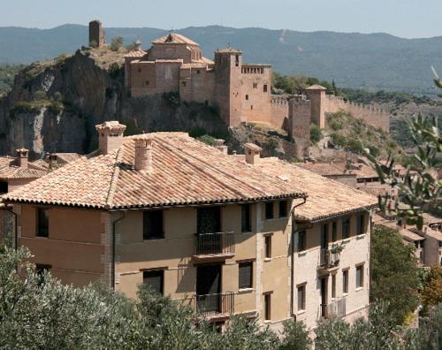 a large building on a hill with a castle at Apartamento Angel e Isabel in Alquézar