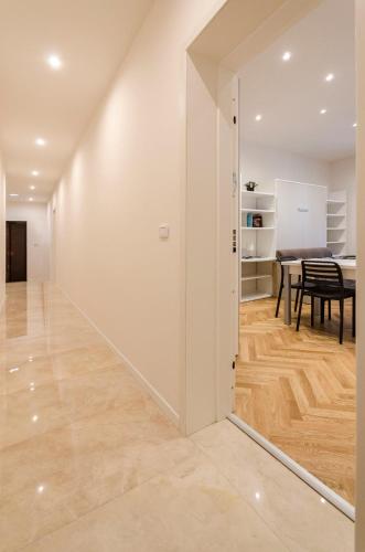 a hallway with a dining room and a table at Calzolerie Luxury Studio in Bologna