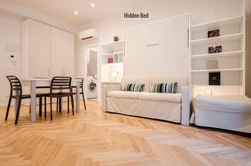 a living room with a couch and a table at Calzolerie Luxury Studio in Bologna