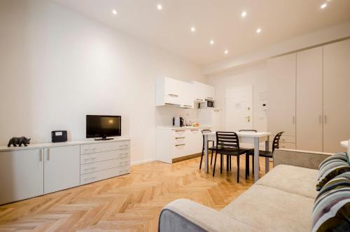 a living room with a couch and a table at Calzolerie Luxury Studio in Bologna
