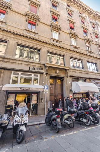 a row of motorcycles parked in front of a building at Calzolerie Luxury Studio in Bologna