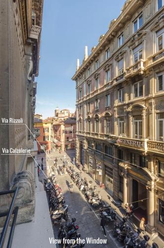 a view from the window of a city street with motorcycles at Calzolerie Luxury Studio in Bologna