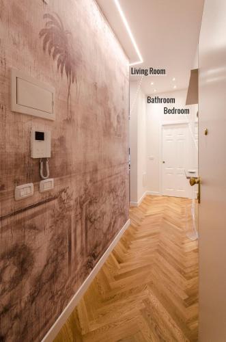 a hallway with a wall mural of a living room and a bathroomoren at Calzolerie Luxury Apartment in Bologna