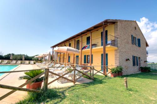a building with a pool in front of it at Casale del Conero in Porto Recanati