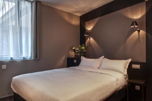 Ένα ή περισσότερα κρεβάτια σε δωμάτιο στο Hotel Les Terres Blanches