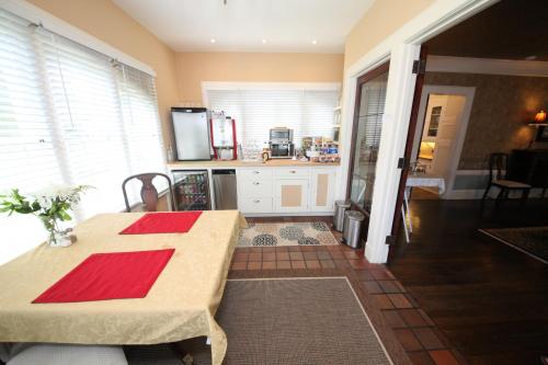 a kitchen with a table with a red cross on it at Leonard at Logan House in Grand Rapids