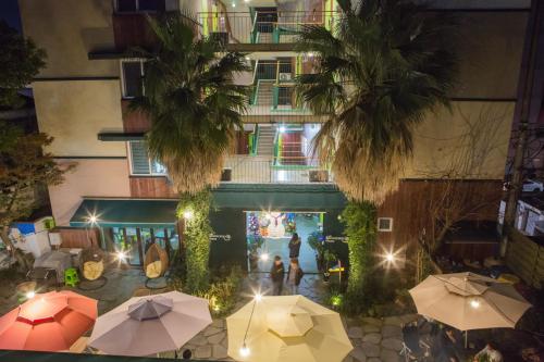 an overhead view of a building with umbrellas in a courtyard at Backpacker's Home in Seogwipo