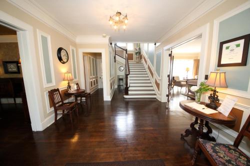 a hallway of a home with a staircase and a living room at Leonard at Logan House in Grand Rapids