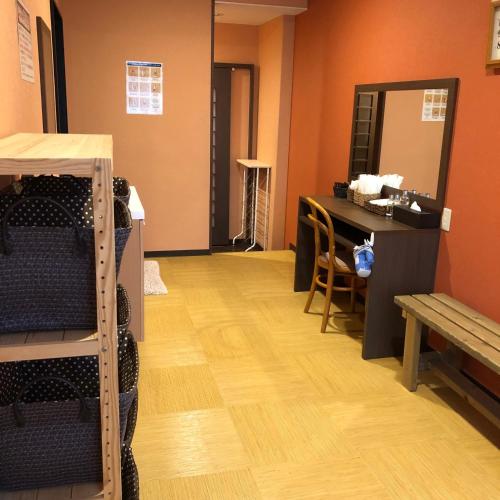 a room with a counter and a table and a shelf at Hotel Tsukuba Hills Gakuen-odori in Tsukuba