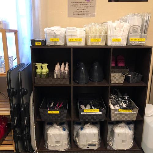 a shelf filled with lots of shoes and other items at Hotel Tsukuba Hills Gakuen-odori in Tsukuba