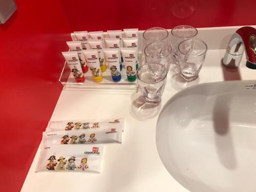 a bathroom counter with glasses and a sink at LEGOLAND Japan Hotel in Nagoya