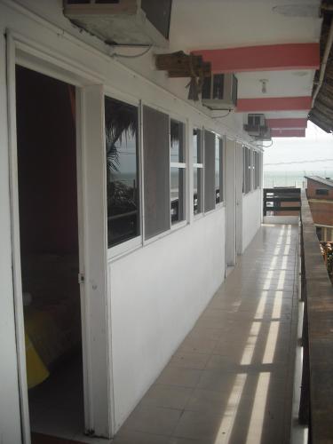 an empty hallway of a building with windows at Hotel Villas del Rey in Chachalacas
