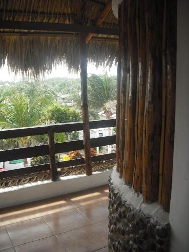 a room with a window with a view of the ocean at Hotel Villas del Rey in Chachalacas