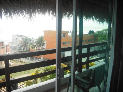 a room with a view of the ocean from a balcony at Hotel Villas del Rey in Chachalacas