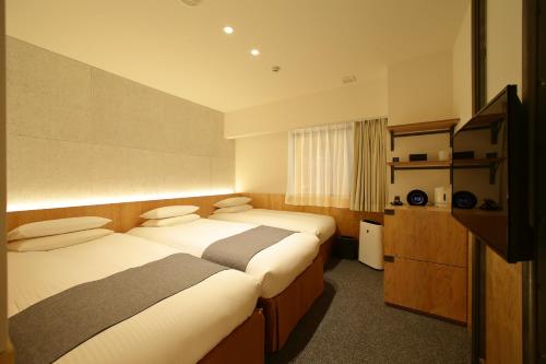 Postelja oz. postelje v sobi nastanitve Hotel Oriental Express Tokyo Kamata