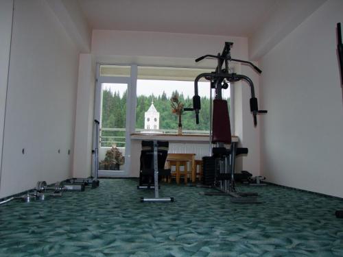 an empty room with a gym with a large window at Hotel Silva in Vatra Dornei
