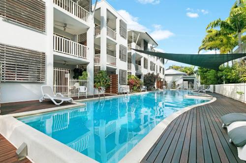 a swimming pool with a pool table and chairs at Mantra Aqueous on Port in Port Douglas