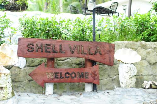 a sign that says shell walk welcome at Shell Villa apartel resort in Koror