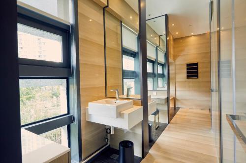 a bathroom with a sink and a mirror at LJZ Supreme Tower Hotel in Shanghai