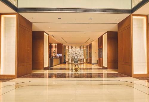 a lobby of a building with a chandelier at LJZ Supreme Tower Hotel in Shanghai