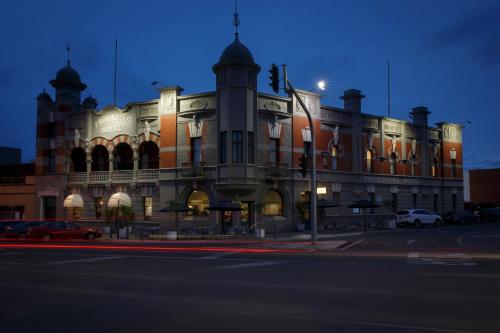 a large building with a clock on the side of it at The Provincial Boutique Hotel in Ballarat