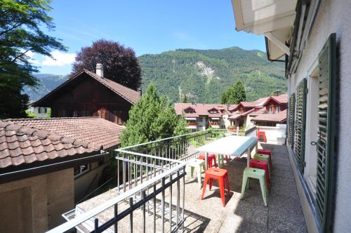 a balcony with a table and chairs on it at Townhouse II Sleeps 12 guests Central in Interlaken