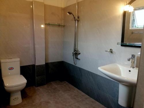 a bathroom with a toilet and a sink at Ella Jayamali Holiday Pavilion in Ella