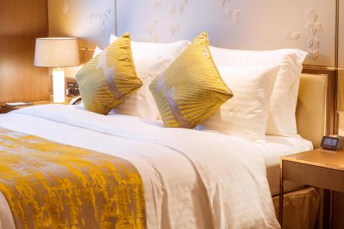 Ένα ή περισσότερα κρεβάτια σε δωμάτιο στο Golden Tulip Shanghai Hongqiao- A Louvre Hotel