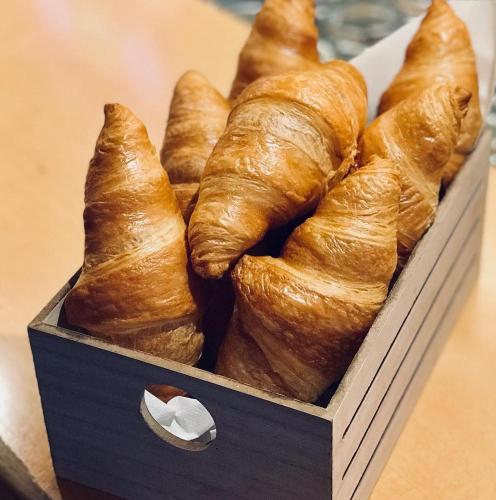 a box of croissants sitting on a table at Pension Bellevue Gondo in Ruden