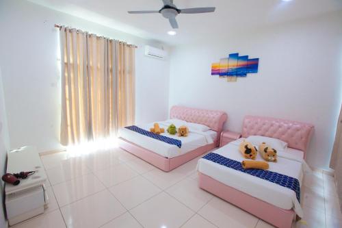 a bedroom with two beds with teddy bears on them at THE ONLY SEA VIEW IN TOWN in Kuah