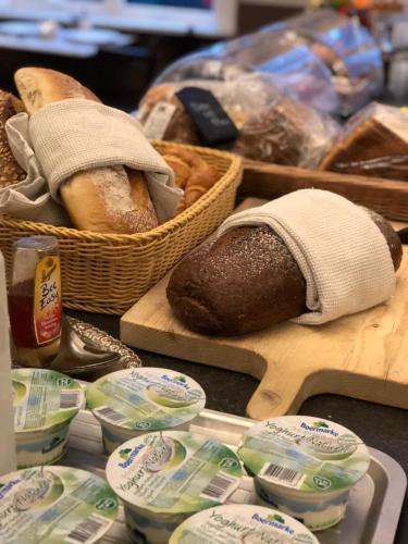 a table topped with bread and baskets of food at Boutique hotel Sint Jacob in Maastricht