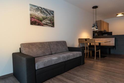 a living room with a couch and a table at A CASA Rubin Chalet & Studio Resort in Sölden
