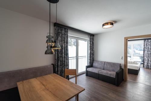 a living room with a couch and a table at A CASA Rubin Chalet & Studio Resort in Sölden