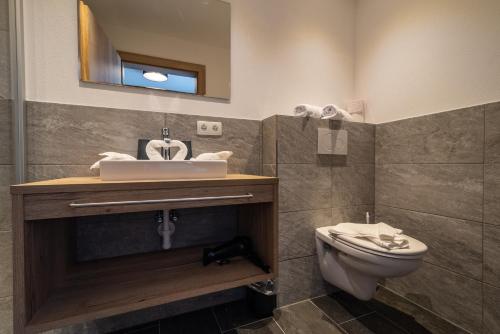 a bathroom with a sink and a toilet at A CASA Rubin Chalet & Studio Resort in Sölden