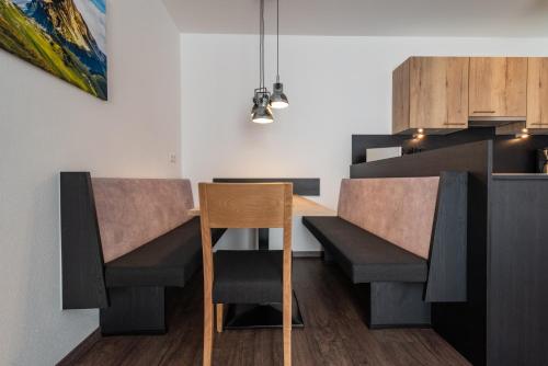 a dining room with a table and chairs at A CASA Rubin Chalet & Studio Resort in Sölden