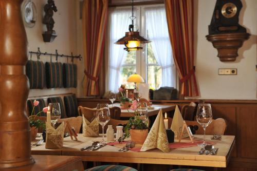 a dining room with a table with wine glasses at Landhotel Voss im TalVital in Saalhausen
