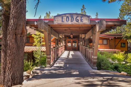 a building with a sign that reads lodge at Happy Family Cozy Cabin in Truckee
