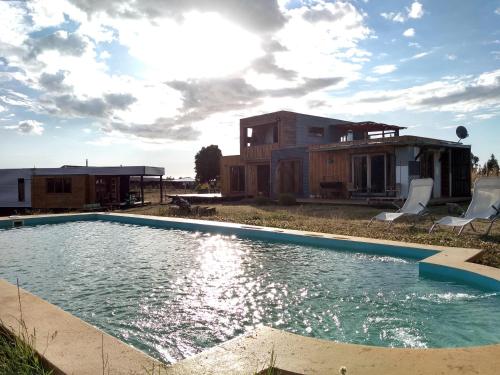 uma piscina em frente a uma casa em Ecolodge Lanalhue Hostel em Cañete