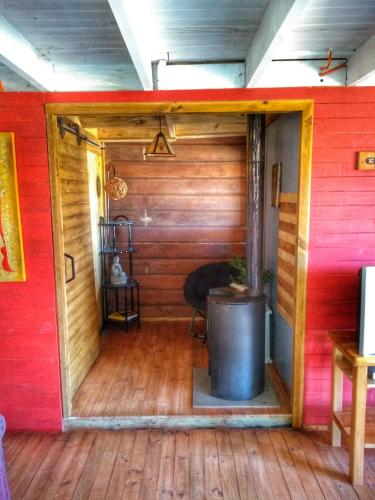 an inside view of a cabin with a barrel in a room at Ecolodge Lanalhue Hostel in Cañete