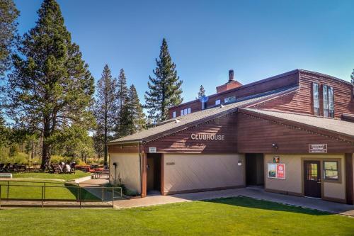 a building with a garage in a yard at Happy Family Cozy Cabin in Truckee