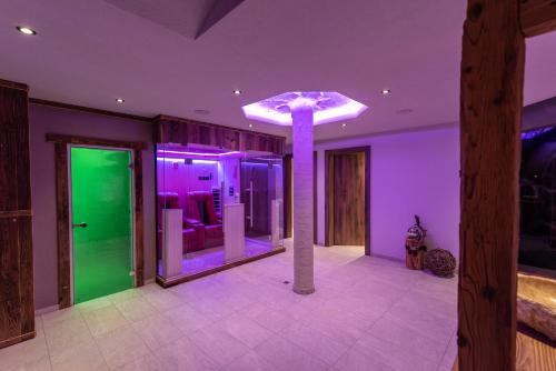 a room with purple and green lights and a pole at A CASA Rubin Chalet & Studio Resort in Sölden