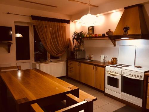 a kitchen with a table and a stove top oven at Візерунок in Delyatyn