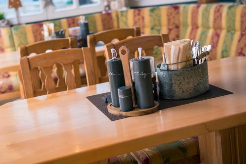 a wooden table with utensils on top of it at smartFLATS in Dorfgastein